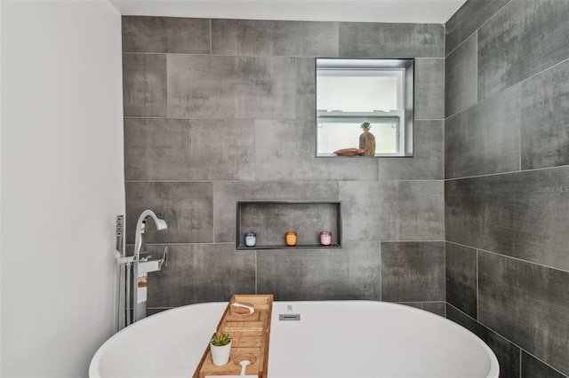 bathroom featuring tile walls and a bathing tub