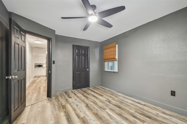 unfurnished bedroom with ceiling fan and light hardwood / wood-style floors