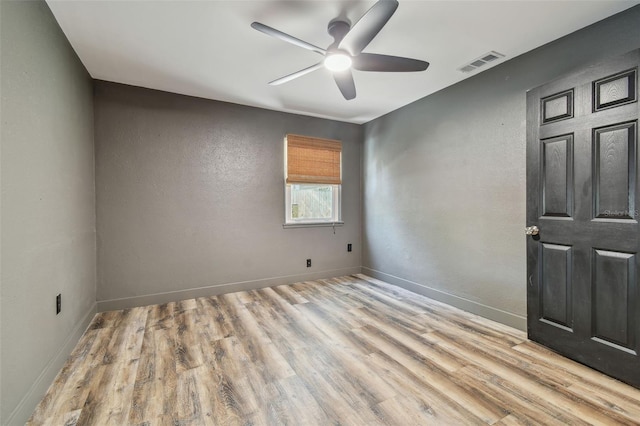 empty room featuring light hardwood / wood-style flooring and ceiling fan