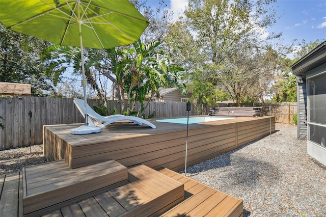 wooden terrace with a covered pool