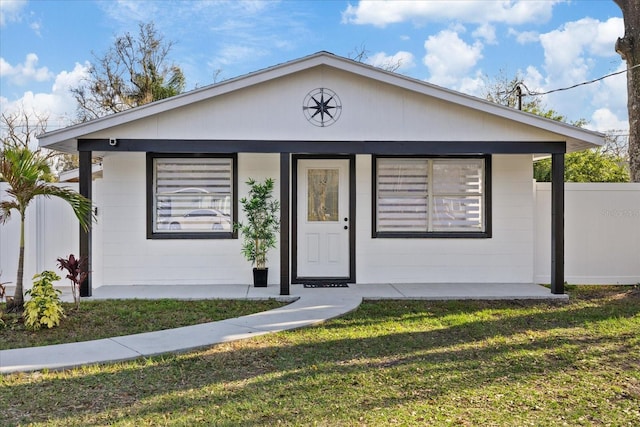 view of front of house with a porch and a front lawn