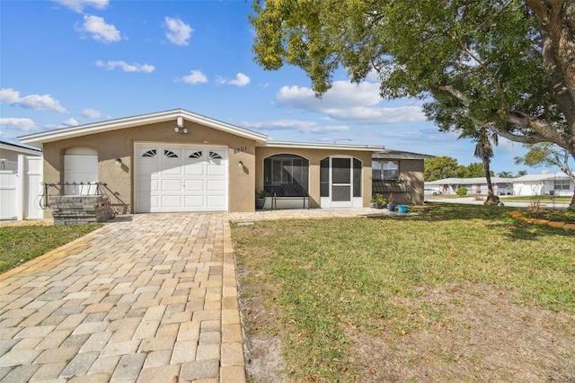 ranch-style home featuring a garage and a front yard