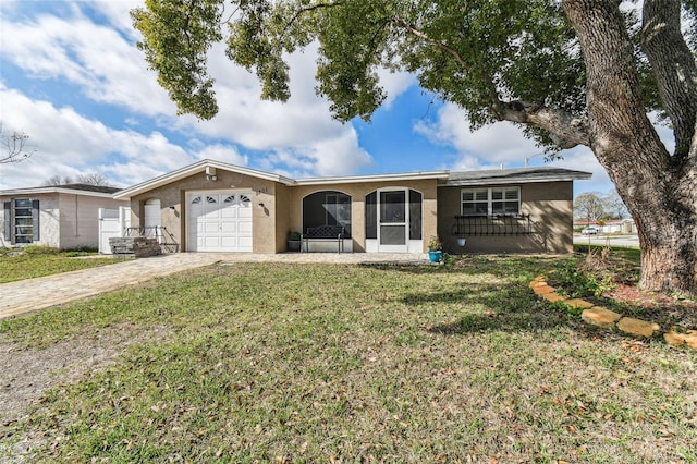 ranch-style house with a garage and a front lawn