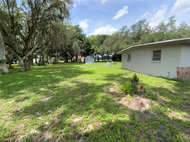 3223 Coats Rd, Zephyrhills, FL 33541 - view of grassy yard featuring a shed