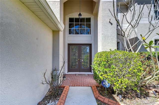 view of exterior entry featuring french doors