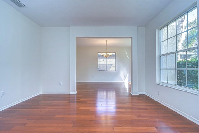 18126 Kara Ct, Tampa, FL 33647 - spare room with a chandelier, dark wood-style flooring, and baseboards