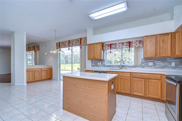 18126 Kara Ct, Tampa, FL 33647 - kitchen with a sink, appliances with stainless steel finishes, tasteful backsplash, light countertops, and light tile patterned flooring