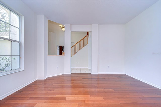 18126 Kara Ct, Tampa, FL 33647 - spare room with wood finished floors, a chandelier, stairs, and baseboards