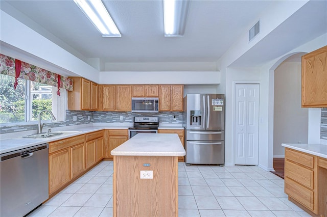 18126 Kara Ct, Tampa, FL 33647 - kitchen with stainless steel appliances, a sink, light countertops, backsplash, and a kitchen island