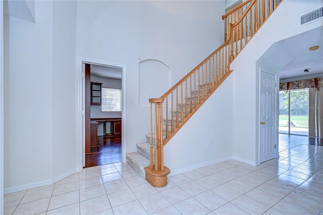 18126 Kara Ct, Tampa, FL 33647 - stairway with a towering ceiling, tile patterned flooring, and baseboards