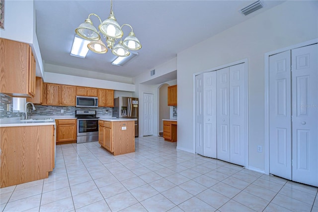 18126 Kara Ct, Tampa, FL 33647 - kitchen with stainless steel appliances, a chandelier, light countertops, backsplash, and light tile patterned floors