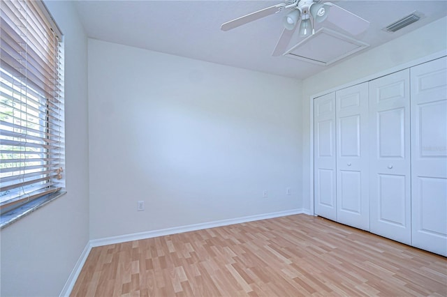 18126 Kara Ct, Tampa, FL 33647 - unfurnished bedroom with light wood-style floors, a closet, baseboards, and attic access