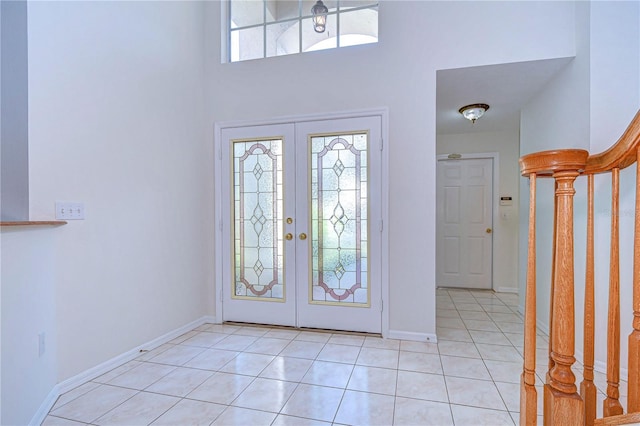 18126 Kara Ct, Tampa, FL 33647 - foyer entrance featuring light tile patterned floors, french doors, a towering ceiling, baseboards, and stairway