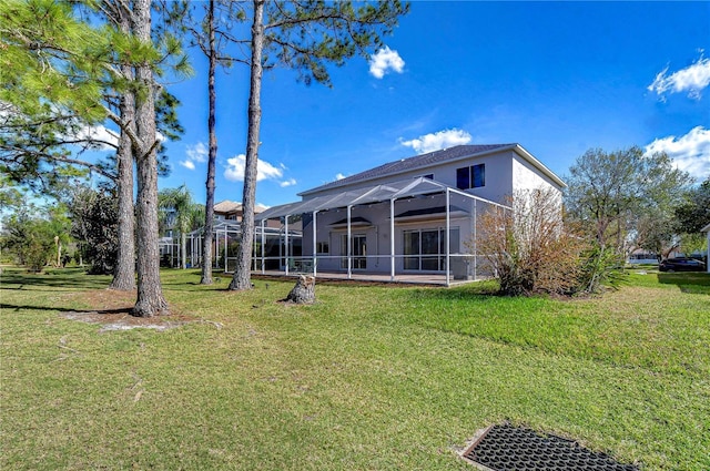18126 Kara Ct, Tampa, FL 33647 - rear view of house with a lawn, glass enclosure, and stucco siding