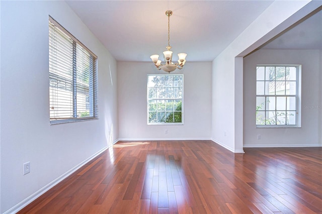 18126 Kara Ct, Tampa, FL 33647 - unfurnished room featuring dark wood-type flooring, a chandelier, and baseboards