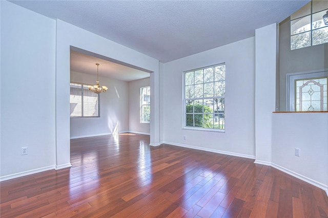 18126 Kara Ct, Tampa, FL 33647 - unfurnished room with a chandelier, wood finished floors, and baseboards