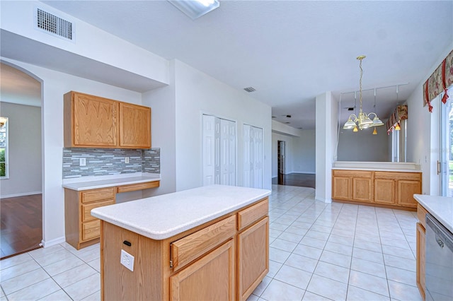 18126 Kara Ct, Tampa, FL 33647 - kitchen with a chandelier, dishwasher, light tile patterned flooring, backsplash, and light countertops