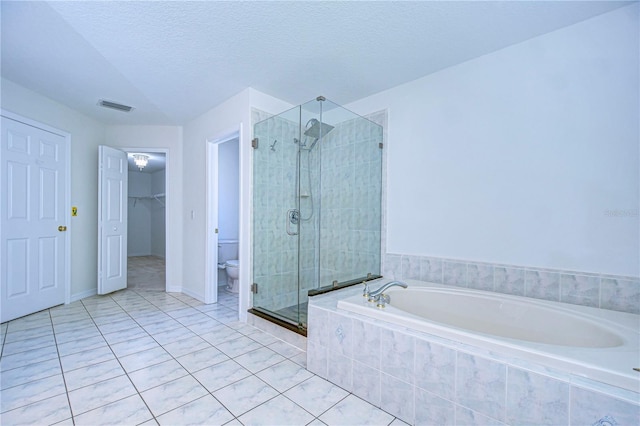 18126 Kara Ct, Tampa, FL 33647 - bathroom featuring a shower stall, toilet, a garden tub, tile patterned floors, and a spacious closet
