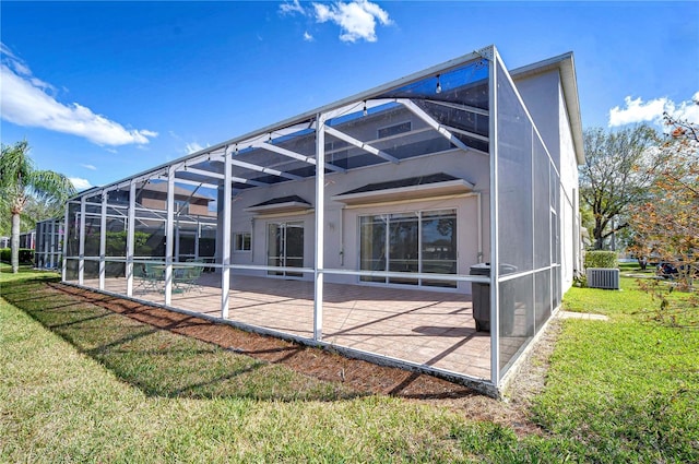 18126 Kara Ct, Tampa, FL 33647 - rear view of property featuring a patio, cooling unit, a lanai, and a lawn
