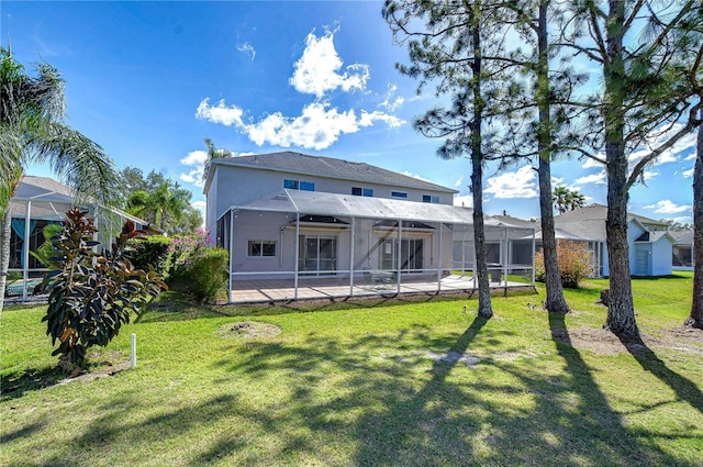18126 Kara Ct, Tampa, FL 33647 - back of house with a lanai, a lawn, a patio, and stucco siding