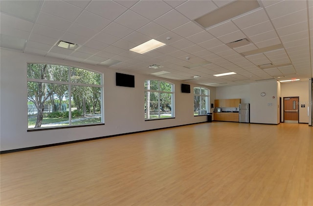 18126 Kara Ct, Tampa, FL 33647 - unfurnished room with light wood-type flooring, a drop ceiling, and baseboards