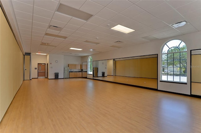 18126 Kara Ct, Tampa, FL 33647 - miscellaneous room with light wood-type flooring, a drop ceiling, healthy amount of natural light, and baseboards