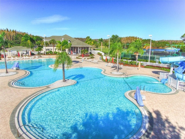 18126 Kara Ct, Tampa, FL 33647 - community pool featuring a water slide and a patio