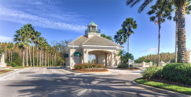 18126 Kara Ct, Tampa, FL 33647 - view of asphalt road with curbs and a gate
