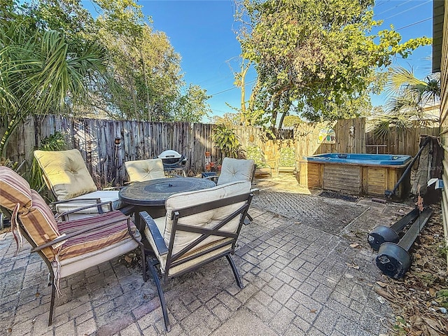 view of patio / terrace with a hot tub