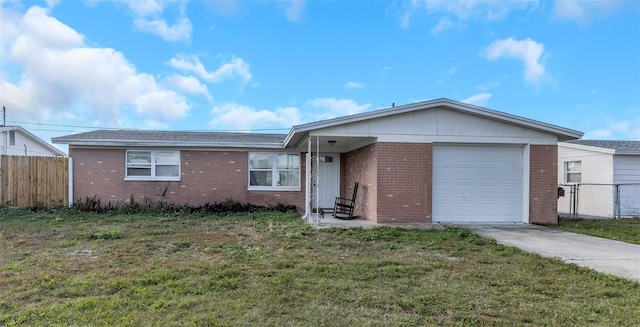 single story home featuring a garage and a front lawn