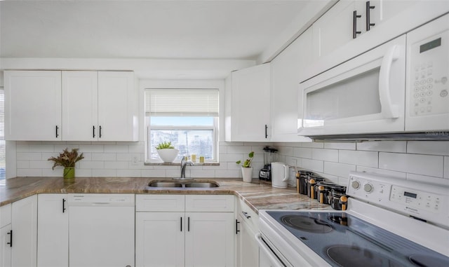 kitchen featuring tasteful backsplash, sink, white appliances, and white cabinets