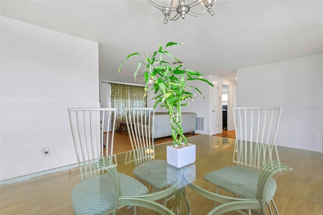 dining room featuring light hardwood / wood-style flooring and a notable chandelier