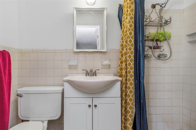 bathroom with vanity, toilet, curtained shower, and tile walls