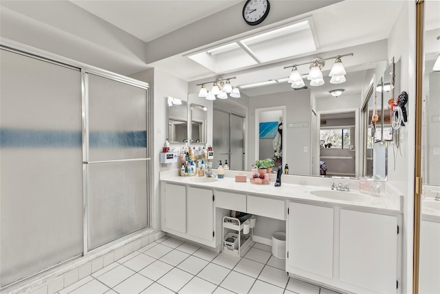 bathroom featuring tile patterned flooring, vanity, and walk in shower