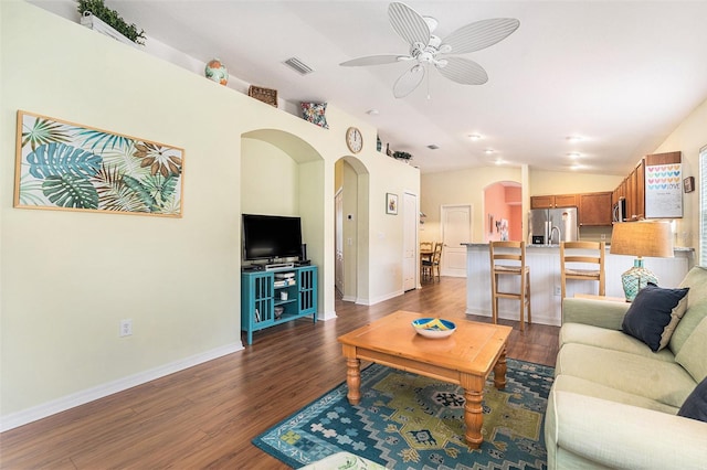 living room with lofted ceiling, dark wood-type flooring, and ceiling fan