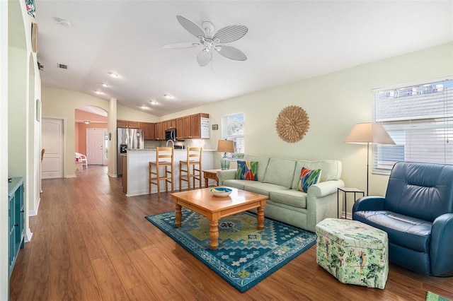 living room with vaulted ceiling, hardwood / wood-style floors, and ceiling fan