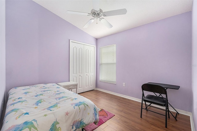 bedroom with lofted ceiling, hardwood / wood-style floors, a closet, and ceiling fan