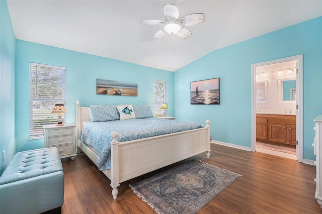 bedroom with ceiling fan, lofted ceiling, dark hardwood / wood-style flooring, and ensuite bathroom