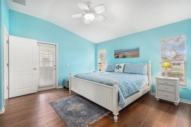 bedroom featuring dark wood-type flooring, ceiling fan, vaulted ceiling, and multiple windows