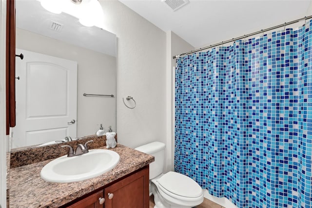 bathroom with toilet, curtained shower, visible vents, and vanity