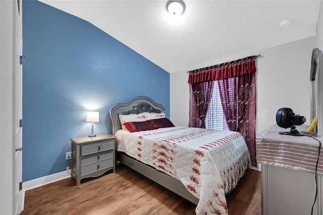 bedroom featuring baseboards and wood finished floors