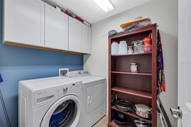 clothes washing area with washer and clothes dryer and cabinet space