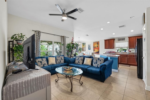 living area featuring recessed lighting, light tile patterned flooring, ceiling fan, and visible vents