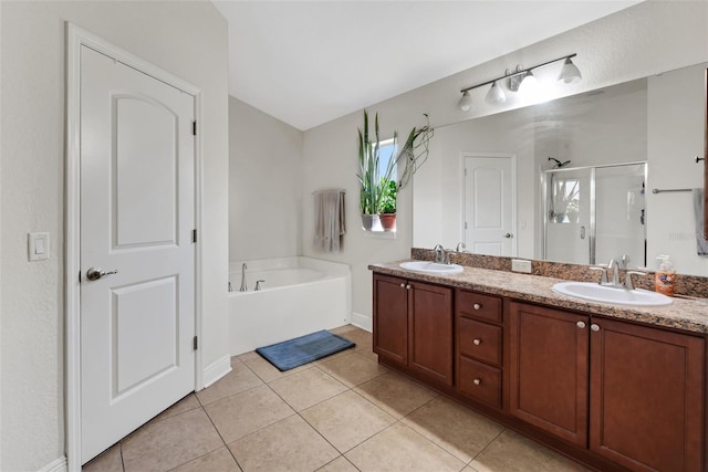 bathroom with double vanity, a sink, a shower stall, and tile patterned floors