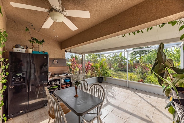 sunroom / solarium featuring a ceiling fan and vaulted ceiling