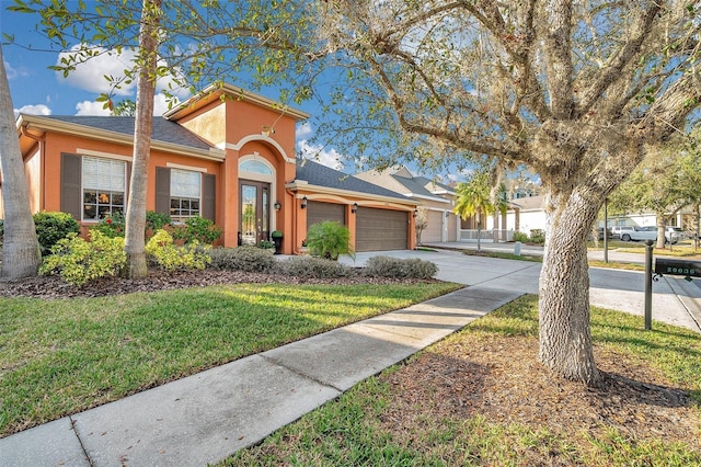 view of front facade with a garage and a front lawn