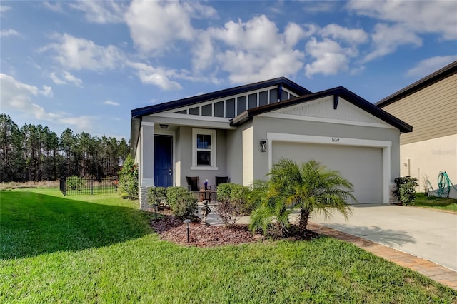 view of front of property featuring a garage and a front yard