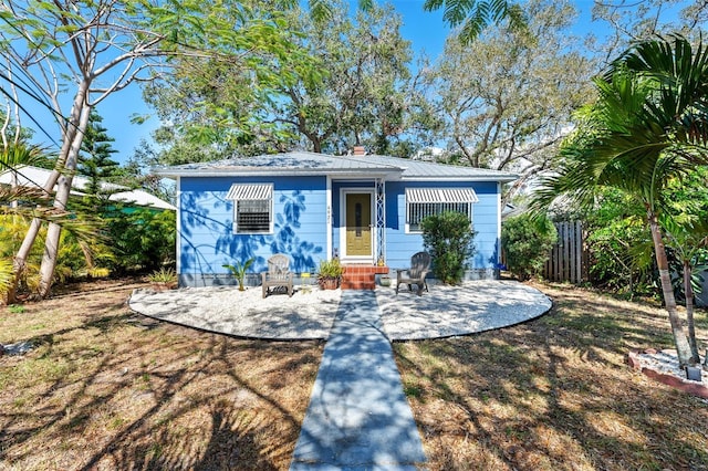 bungalow-style home featuring a patio and a front yard