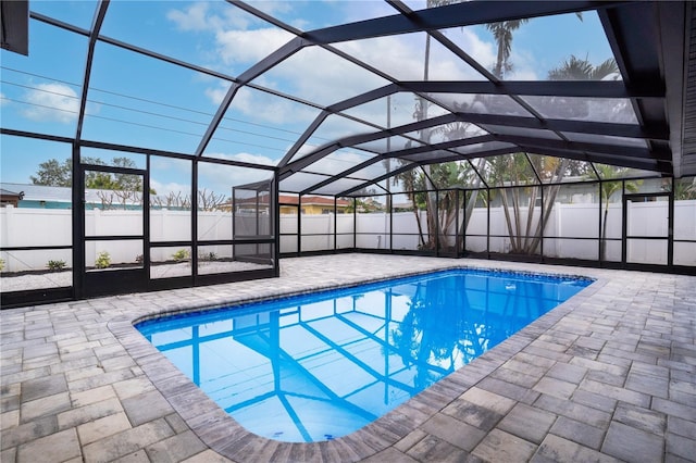 view of swimming pool with a lanai and a patio area