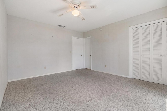 unfurnished bedroom featuring ceiling fan, carpet floors, and a closet